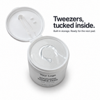 Open white toner pad jar showing built-in tweezer storage and an inner seal